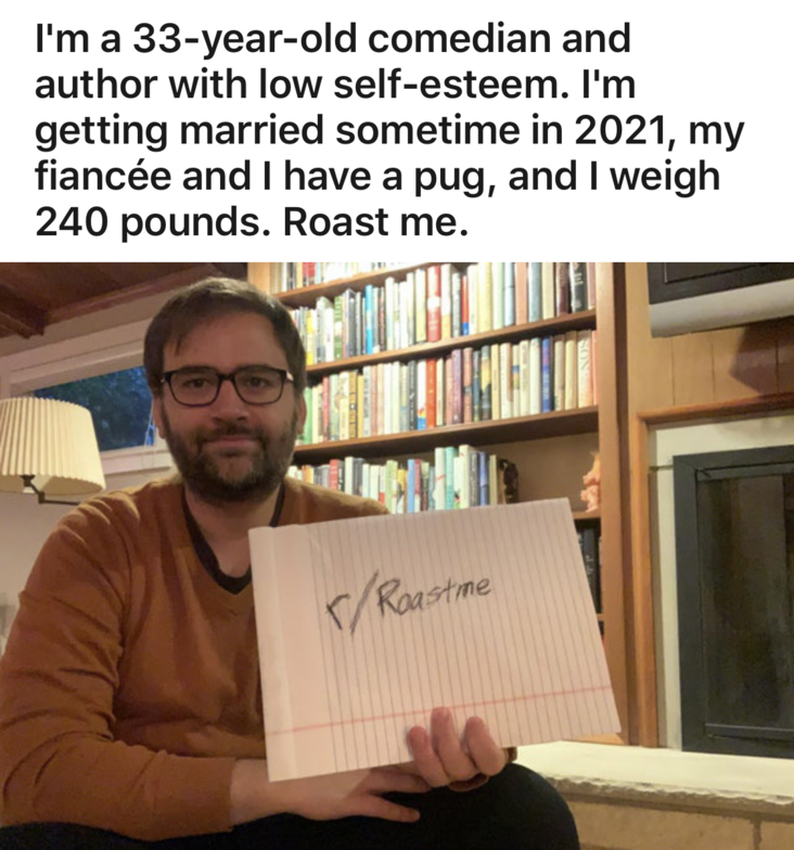 Dan Wilbur writer and comedian holding roast me sign and informing people he owns a pug and weighs 240 pounds