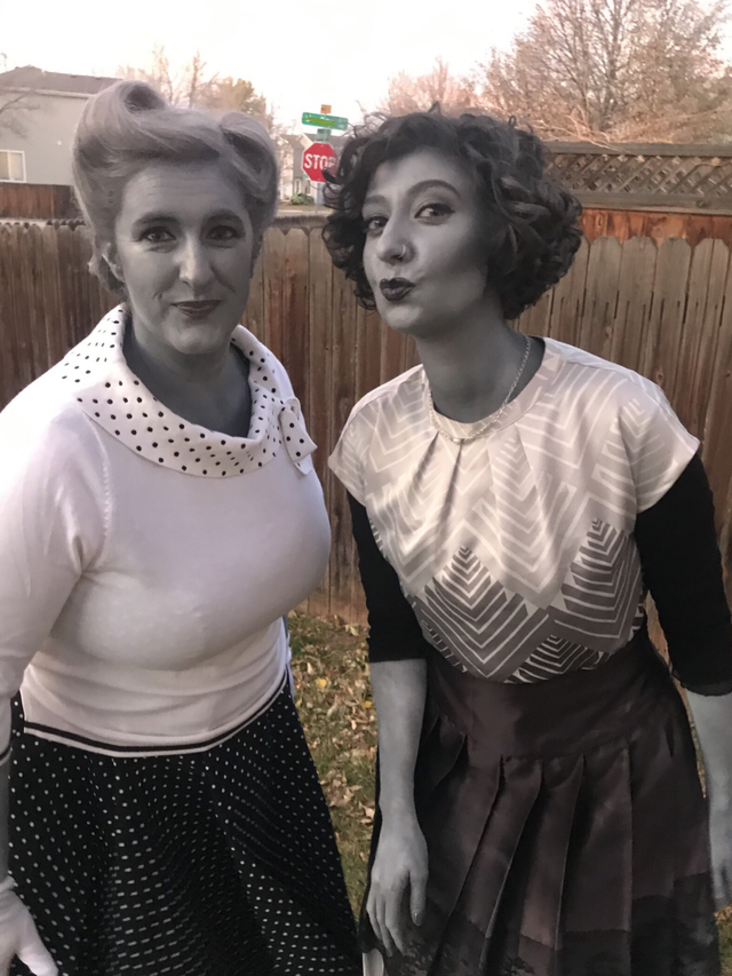 Two women with make up that makes them look like they're in black and white
