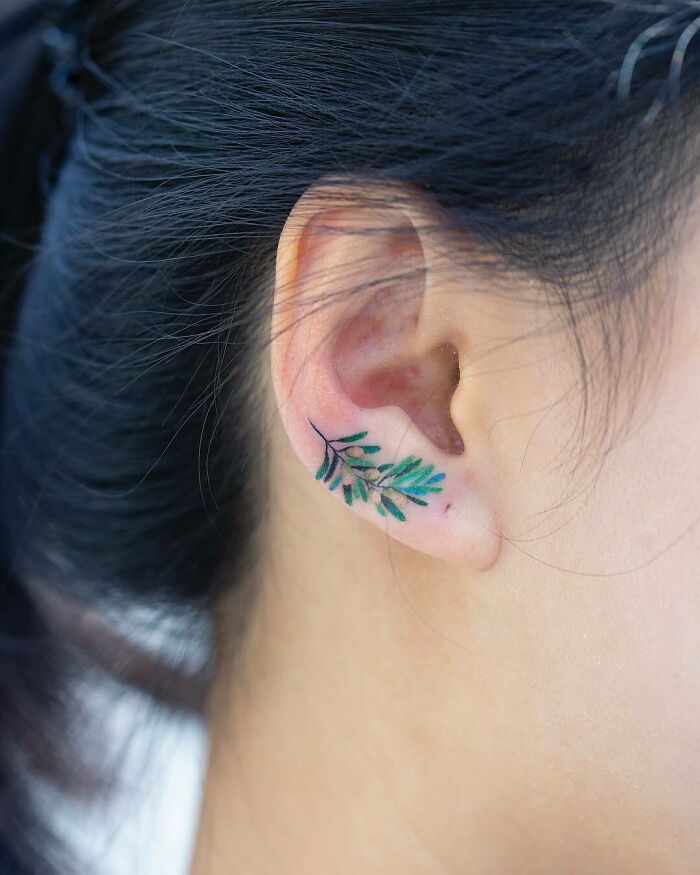cool first tattoo ideas - small branch on earlobe
