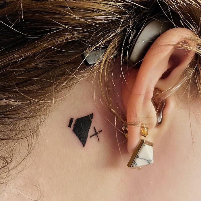 cool first tattoo ideas - mute symbol behind the ear