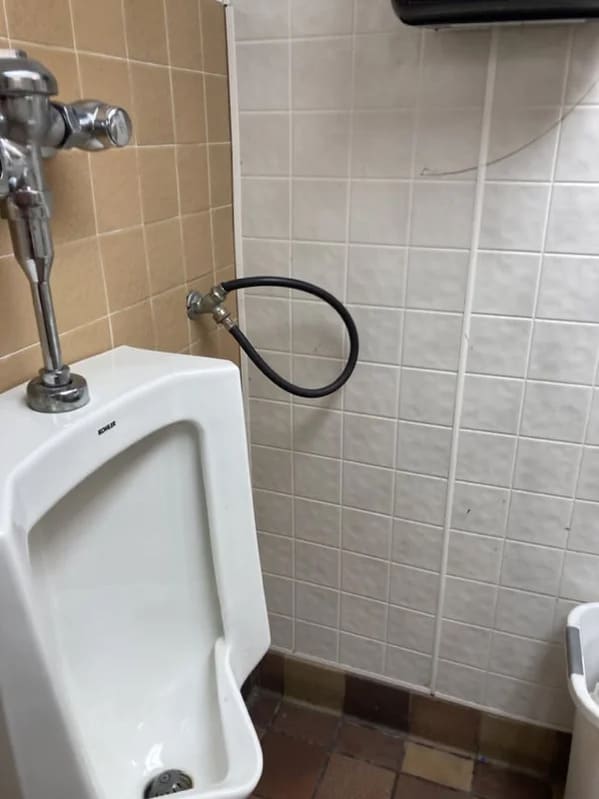 plumbing fails - hose hanging out of wall