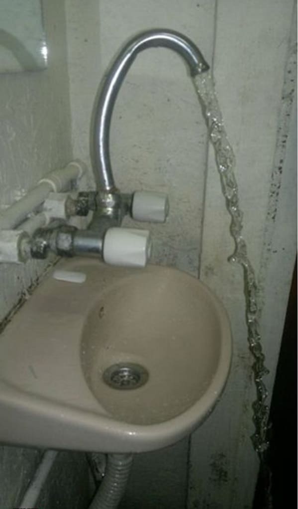 plumbing fails - sink faucet misses sink