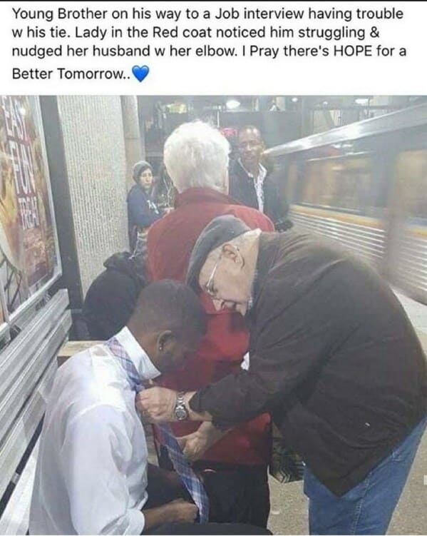 bros helping bros - man ties tie for young man on train platforrm