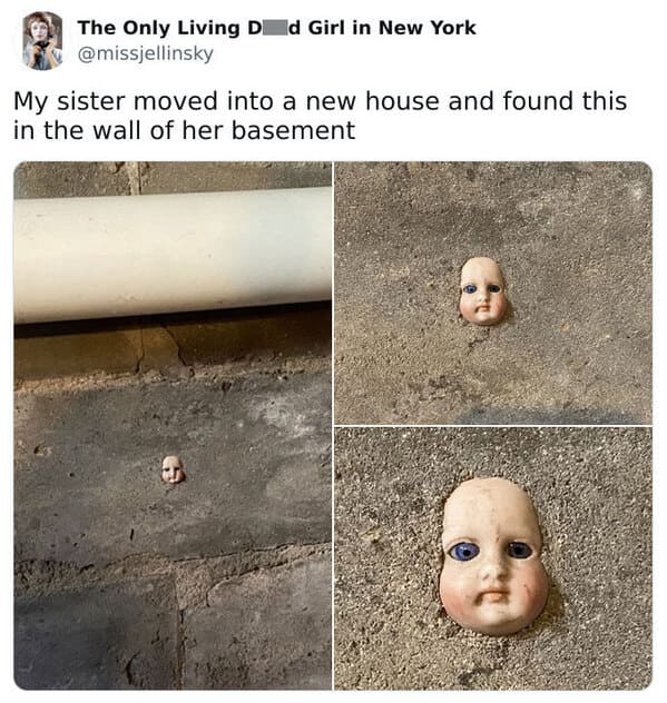 creepy discoveries new home - wall baby doll in cement