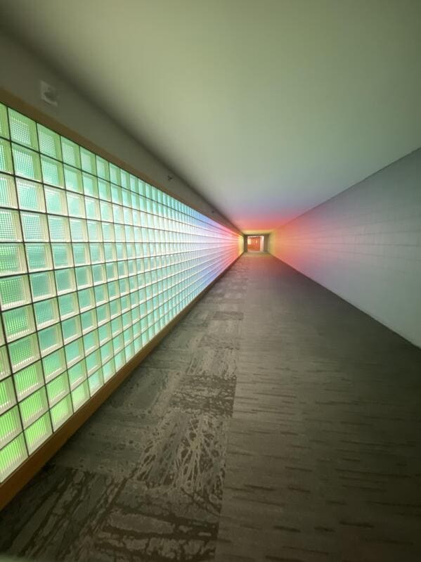 liminal space - long hallway tunnell glass block windows