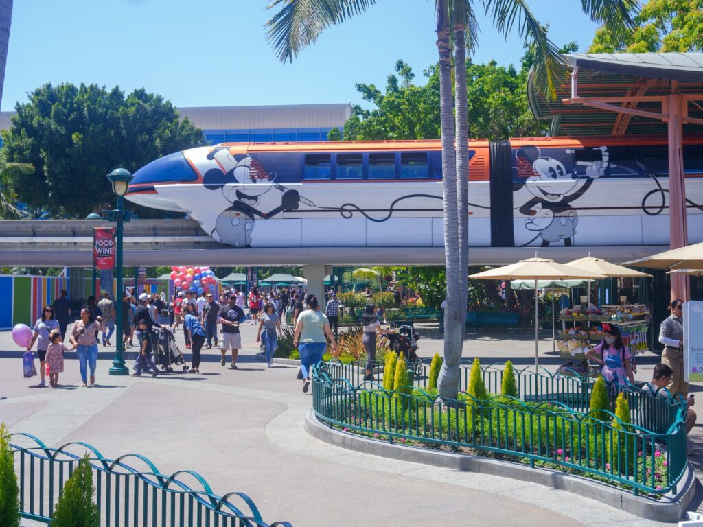 a crowd of people walking around a train station