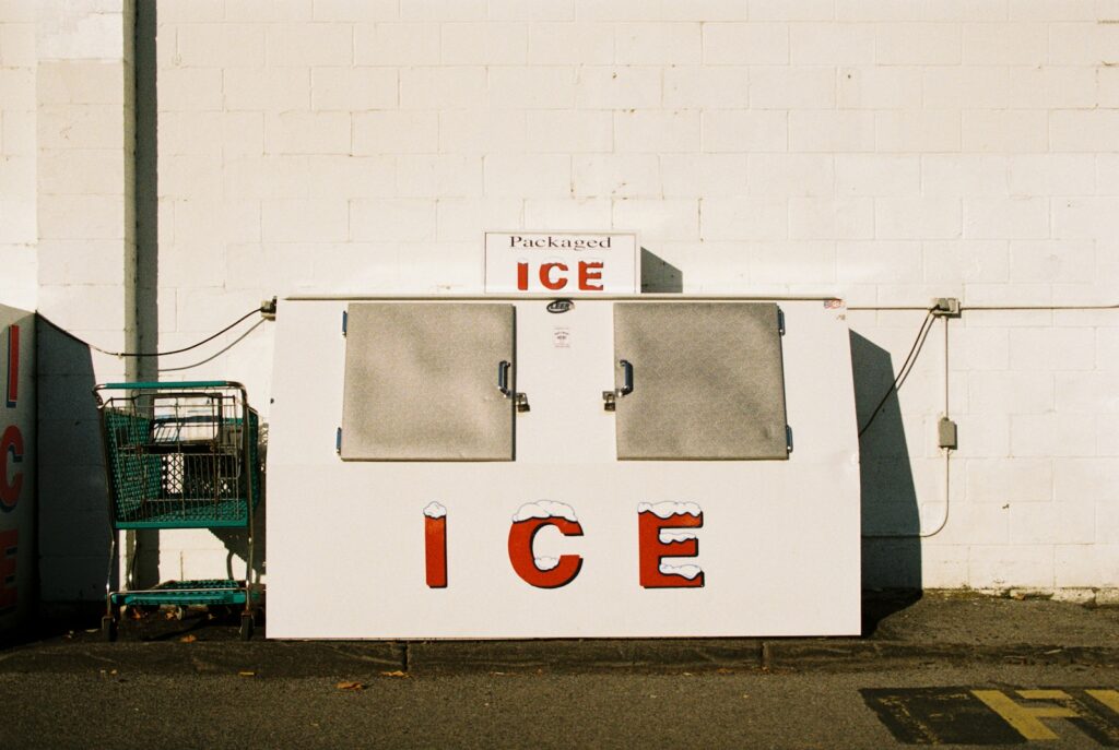 an ice cream stand with a shopping cart in front of it