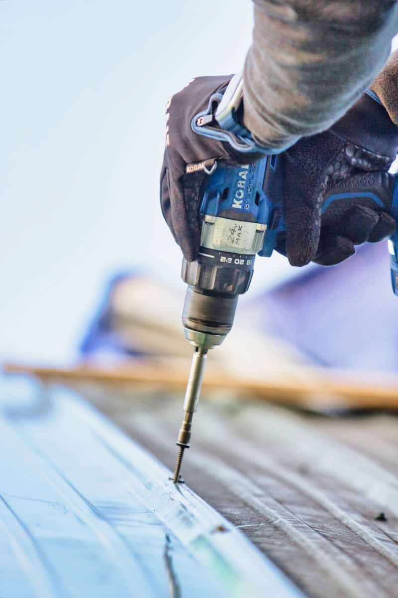 a person using a drill to drill a piece of wood