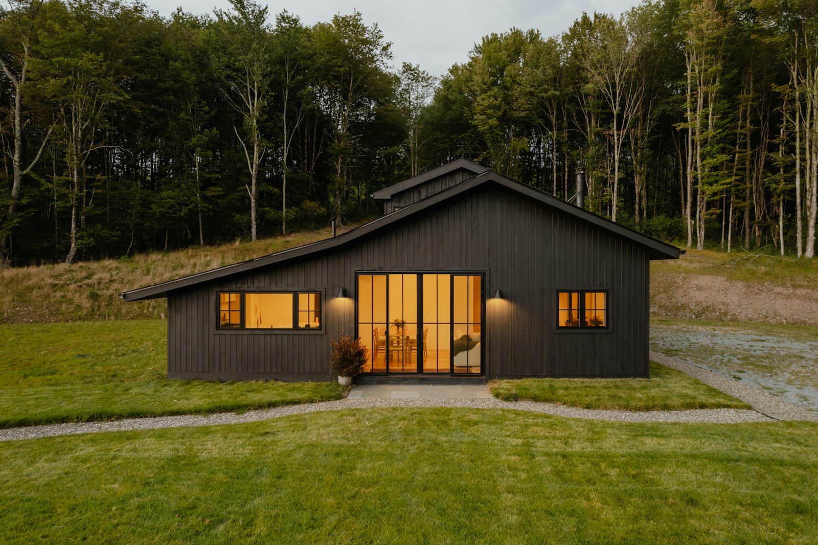 A small black house with a lot of windows