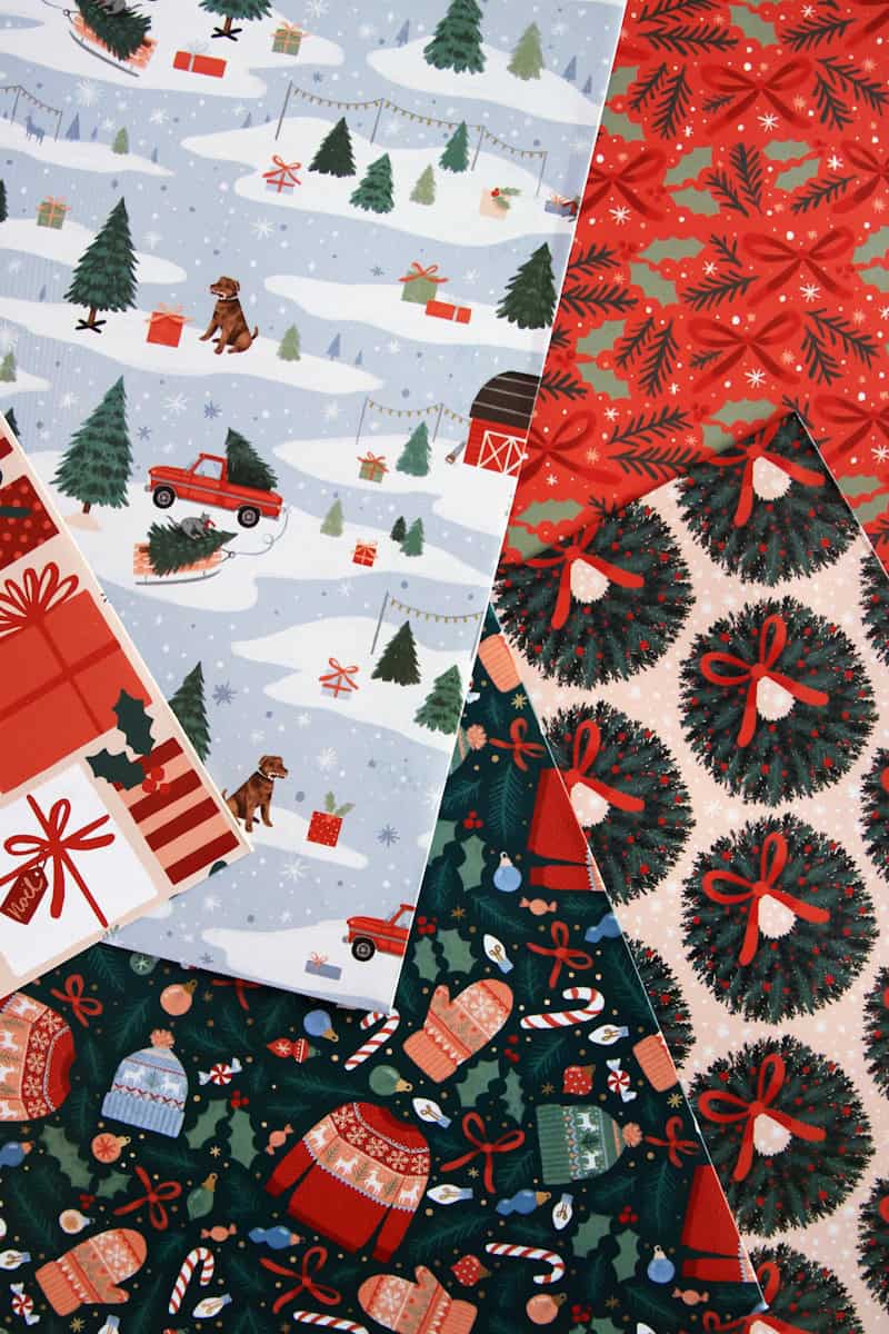 a pile of christmas wrapping paper on top of each other