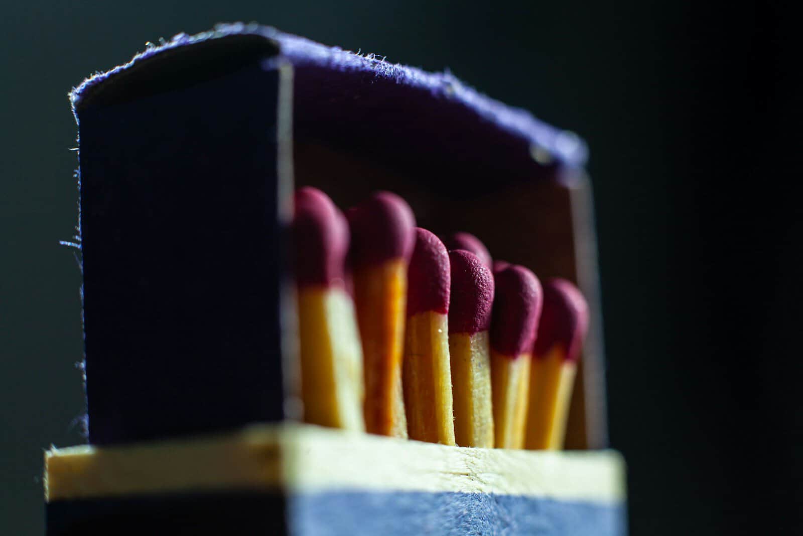 a group of colored pencils in a case