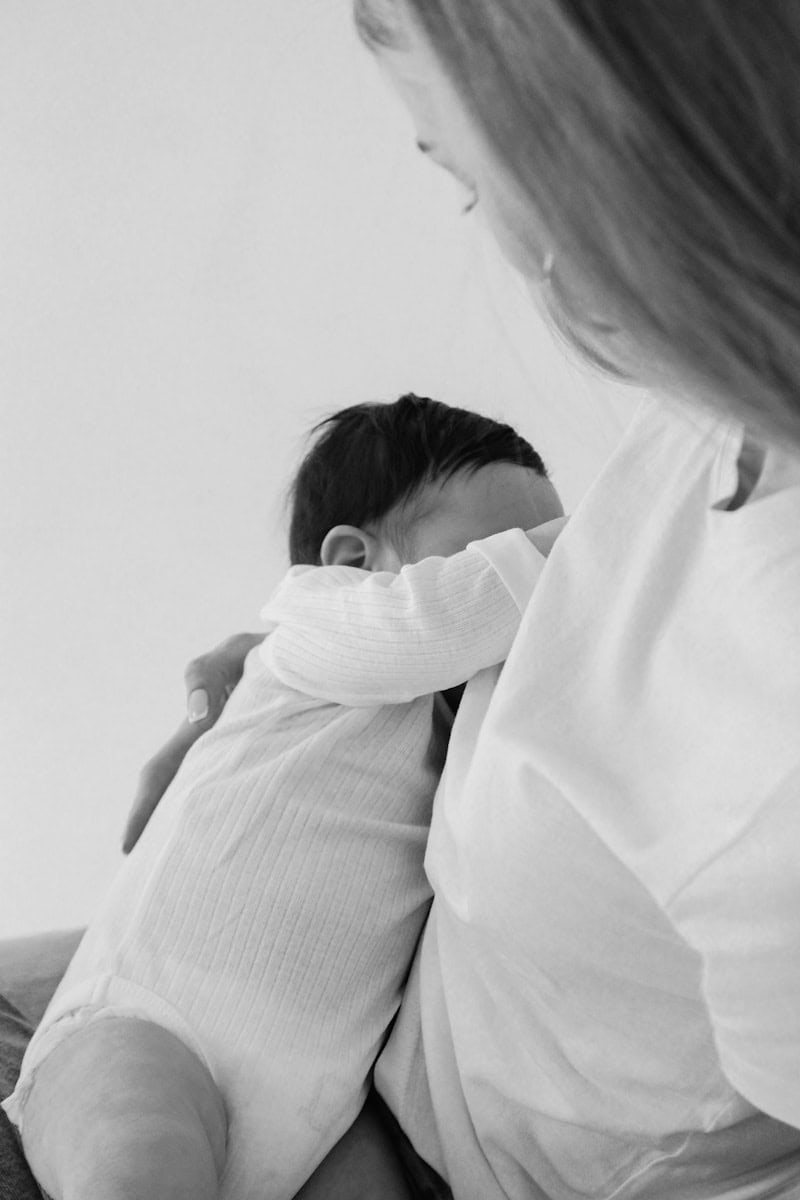 a woman holding a baby in her arms