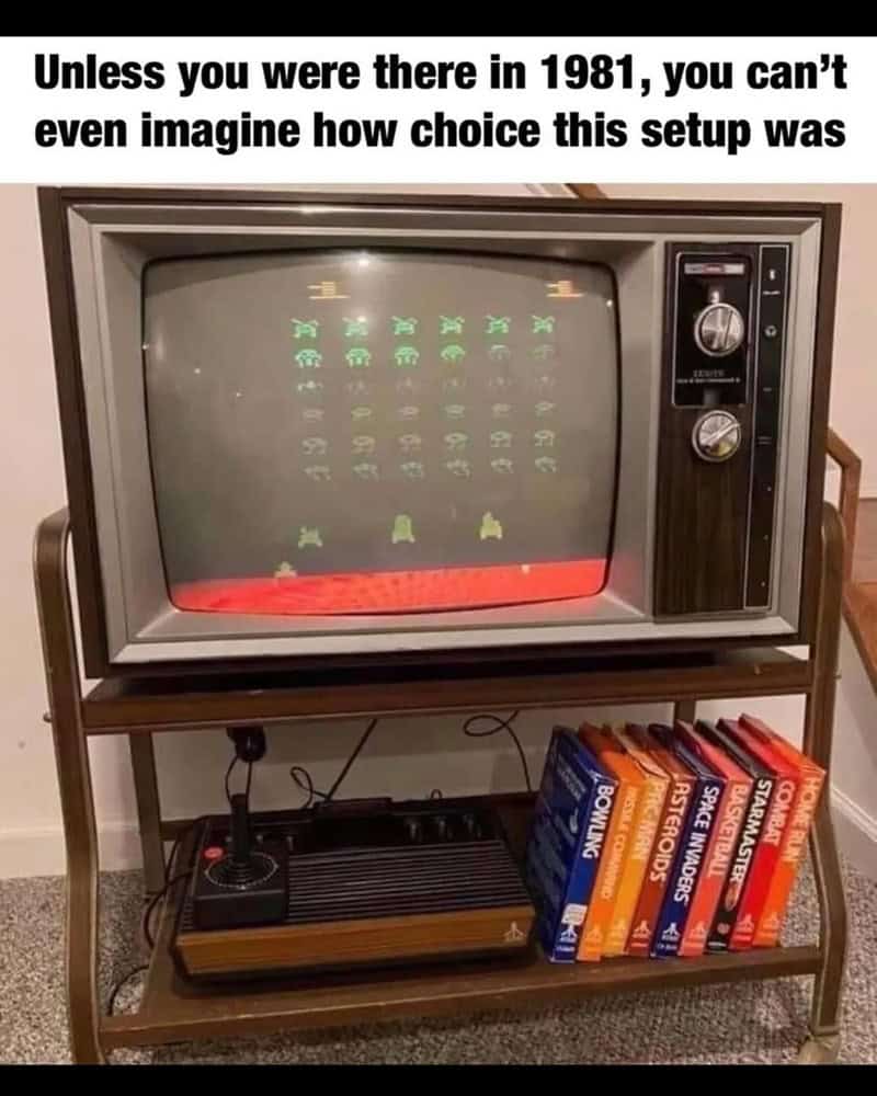 Vintage CRT TV with classic arcade game graphics and a collection of old gaming books.