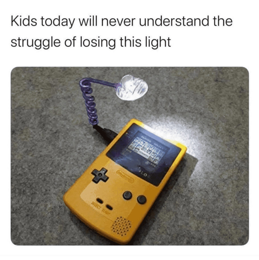 Game Boy Light with lamp, vintage handheld gaming console, nostalgic tech.