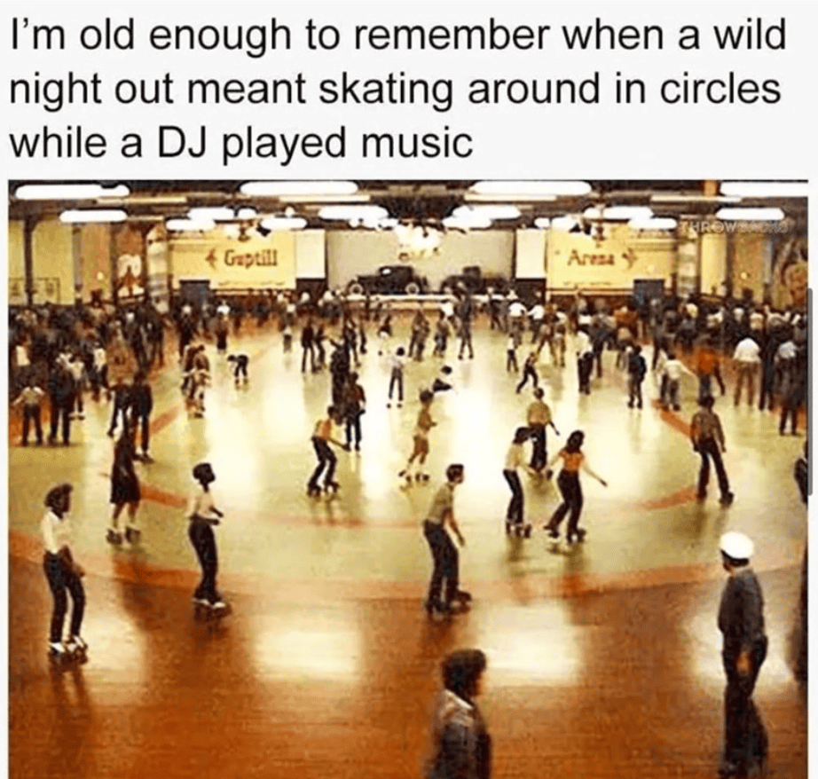 Skaters enjoying a lively night at the roller skating rink with a DJ playing music.