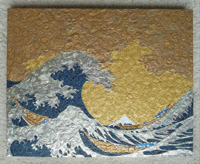 Artistic wave design created with bubble wrap and metallic paint, showcasing textured ocean waves.
