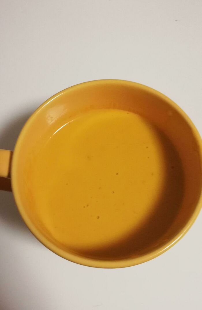 Creamy yellow soup served in a yellow bowl, perfect for comfort food or a cozy meal.