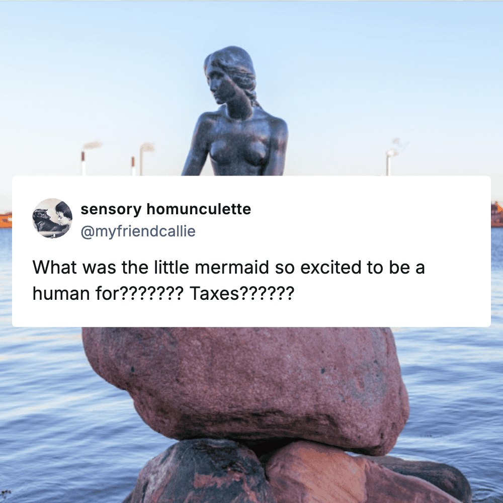 Bronze statue of the Little Mermaid sitting on a rock by the water.