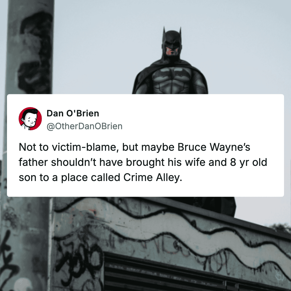 Batman figurine standing on graffiti wall, urban street art scene with a Batman figure.