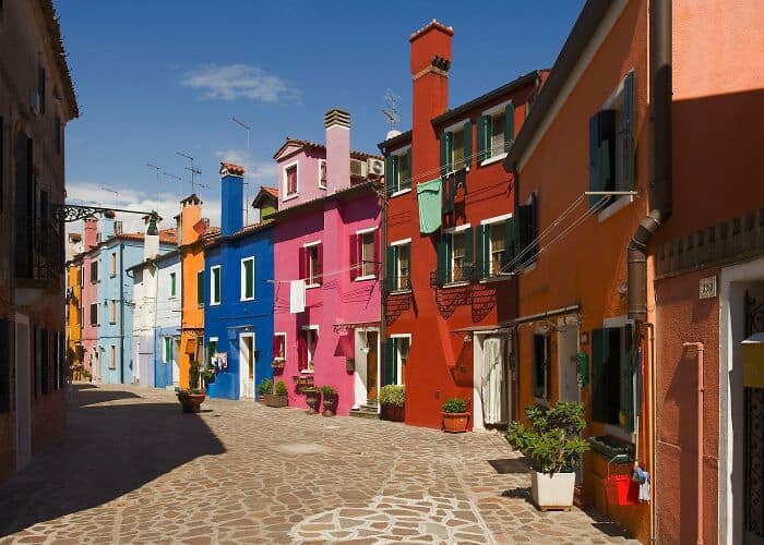 Vibrant colorful houses in a European city street with cobblestone pavement and charming architectur.