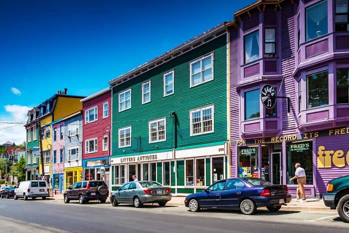 Bright, colorful cityscape featuring multicolored buildings and busy street scene.