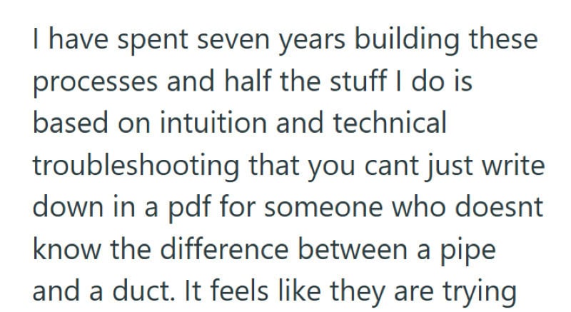 Employee creating detailed manual for outsourced staff training.