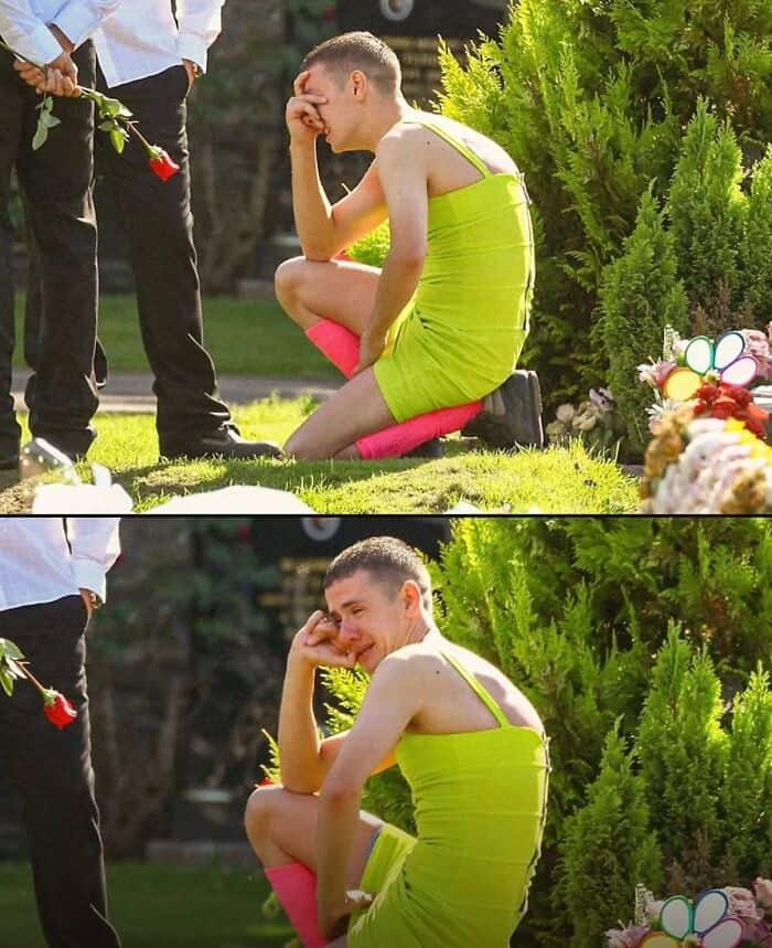 Emotional young man in yellow dress kneeling at a memorial, showing grief and sadness during a sombe.