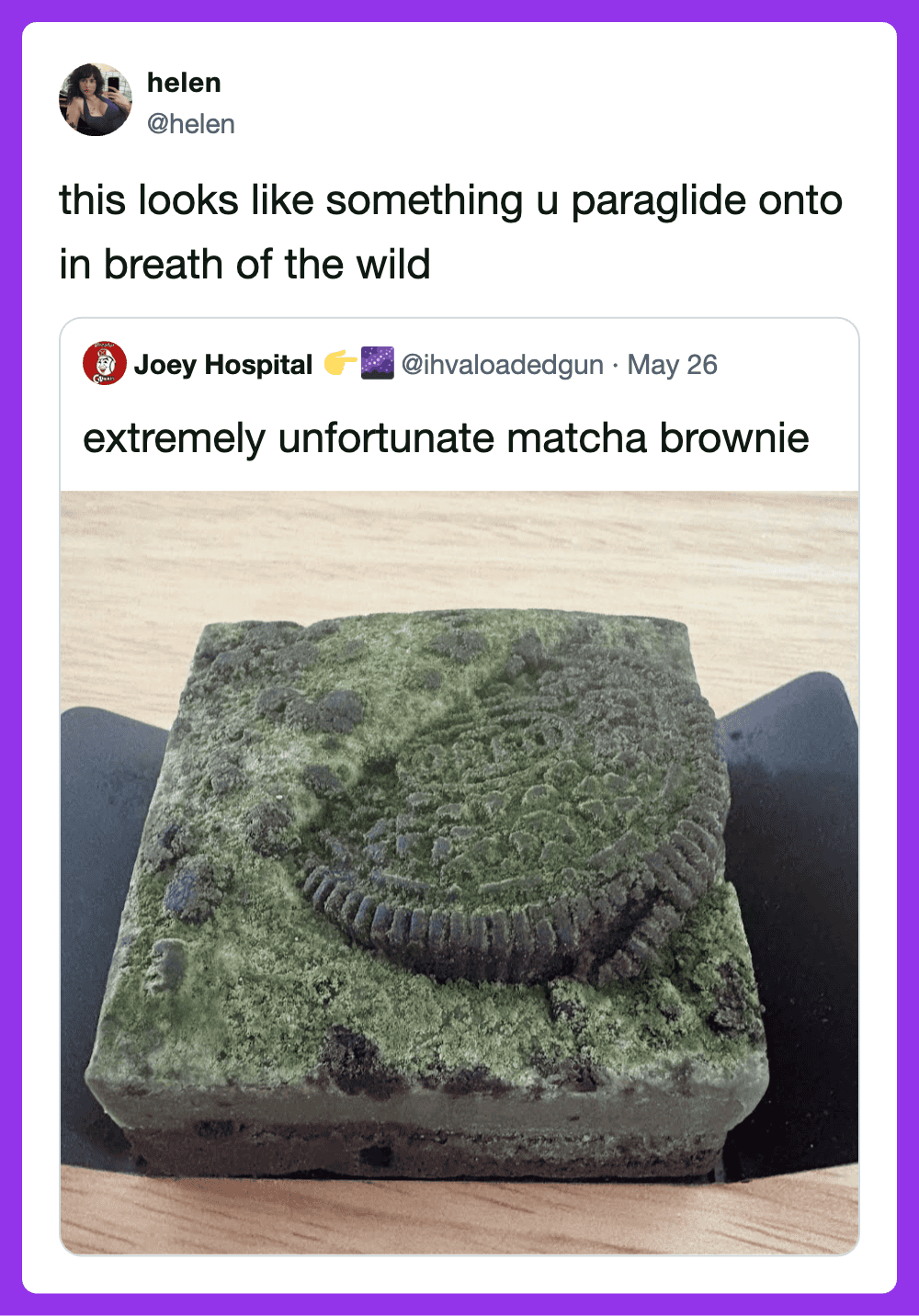 Paraglider on a mossy brownie-shaped object, looks like a brownie in the wild.