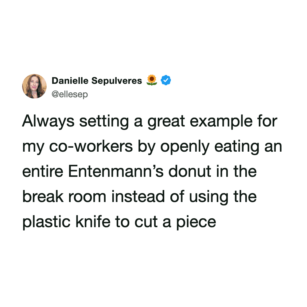 Woman eating donut in break room, humorous workplace moment.
