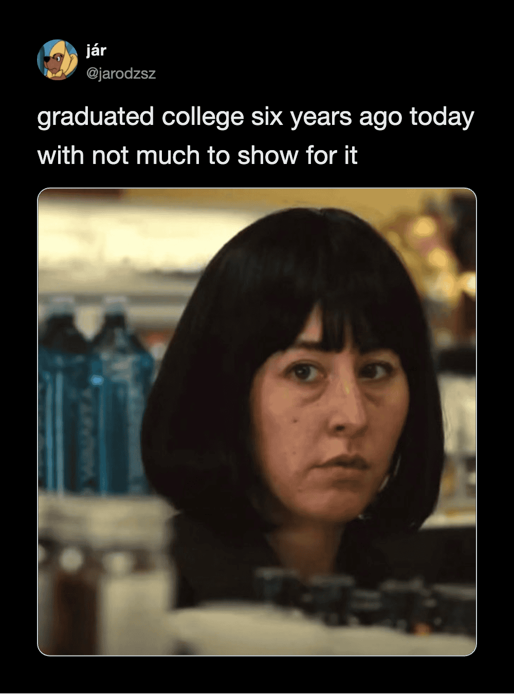 Woman with black hair and bangs, looking serious, in a store setting.