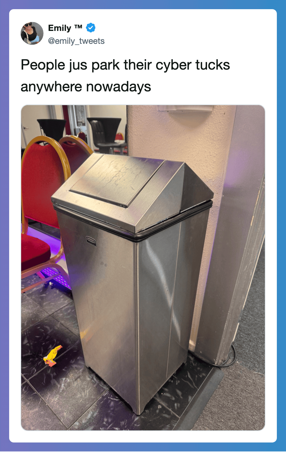 Modern stainless steel trash can with slanted lid in an office setting.