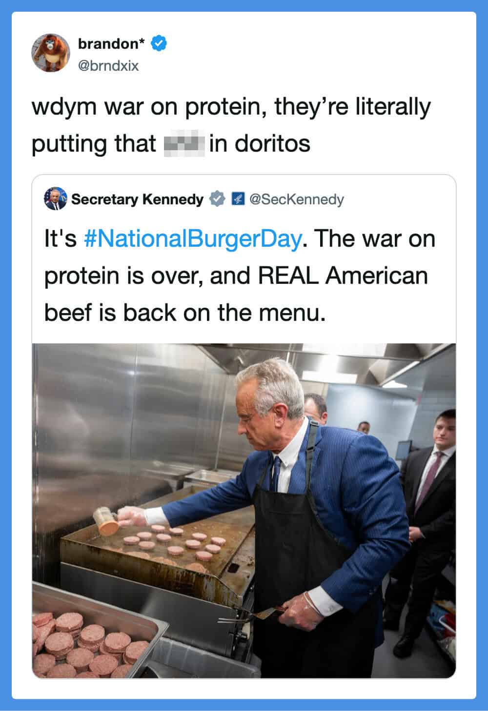 Grilling burgers in a professional kitchen with a man in a blue suit and apron.