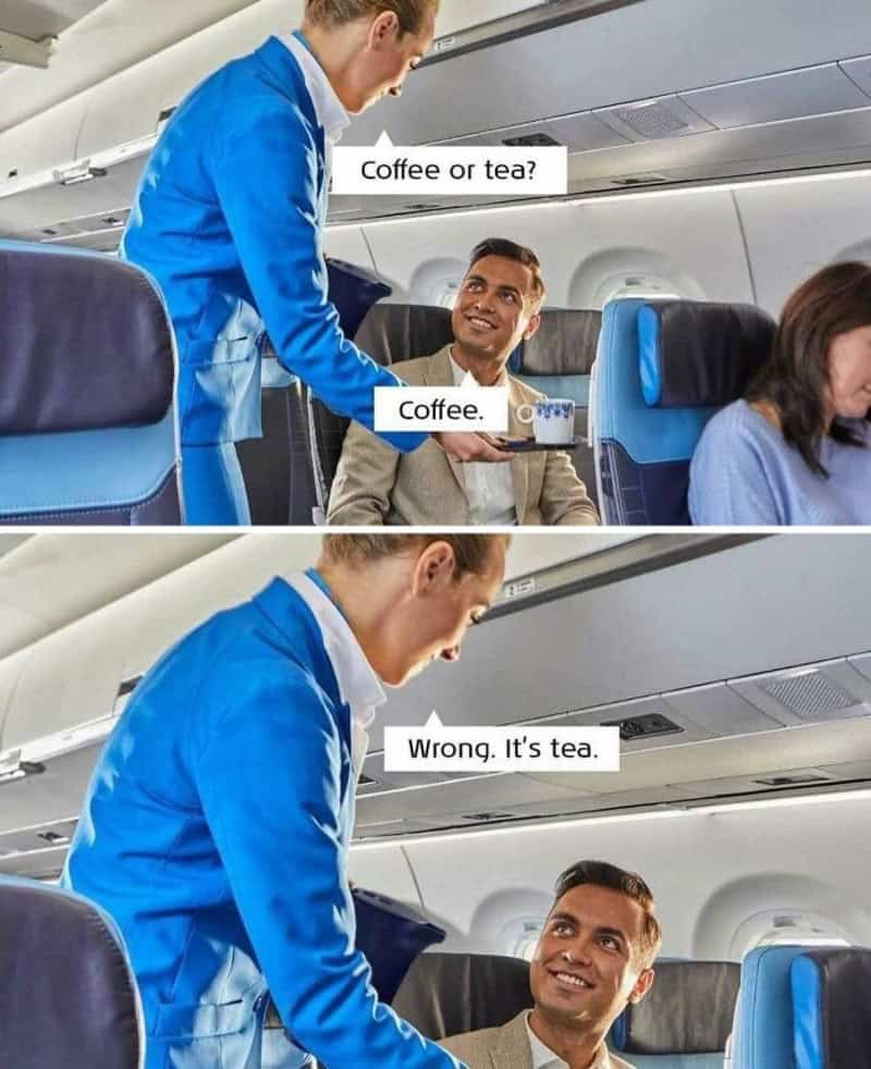 Flight attendant offers coffee to passenger on airplane.