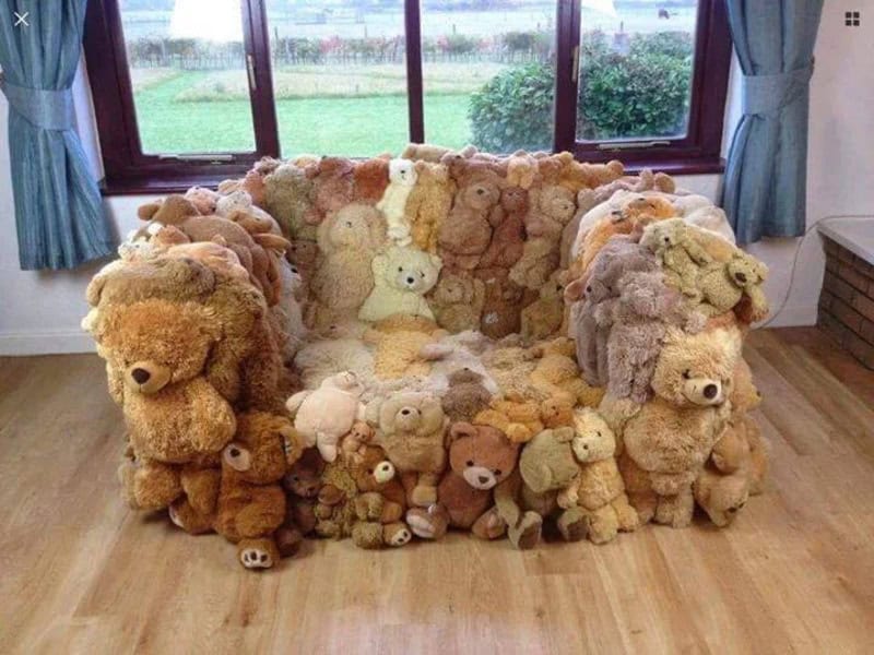 Teddy bear sofa made of numerous plush bears creating a cozy, whimsical furniture piece.
