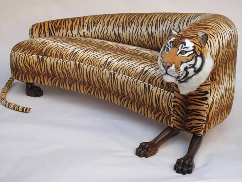 Tiger sofa with animal print fabric and detailed wooden legs for unique home decor.