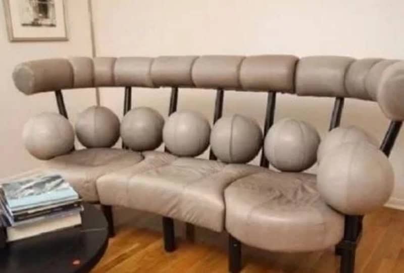 Quirky spherical sofa with pleated fabric and round cushions in a living room.