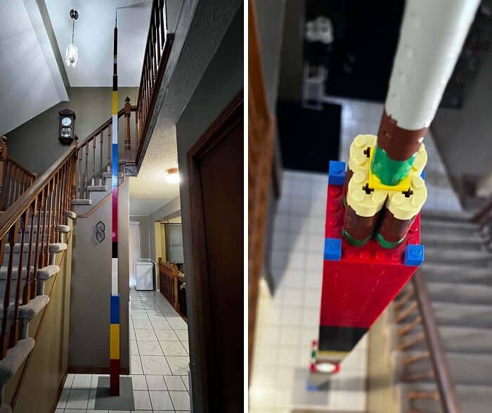 Tall LEGO tower built with colorful bricks in a house hallway.