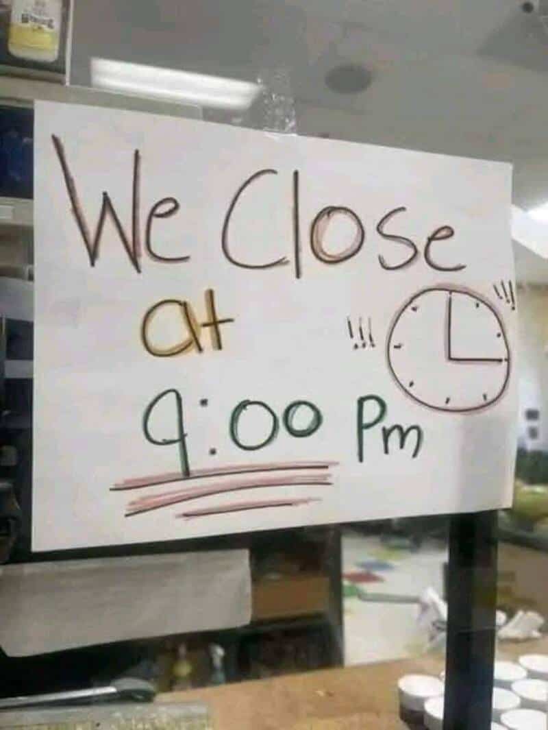 Sign indicating store closes at 9:00 pm with handwritten text and clock illustration.