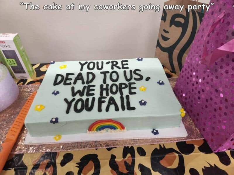 Humorous birthday cake with "You're dead to us" message and rainbow decoration.