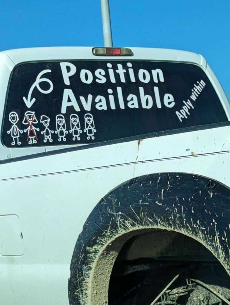 Humorous parking sign showing "6 Position Available" with cartoon kids illustration and playful mess.