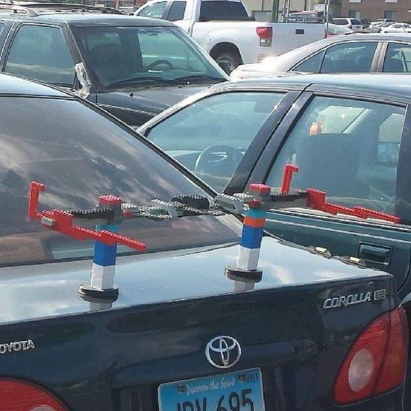 Toy car race on parked vehicles, humorous scene from funny pictures collection.