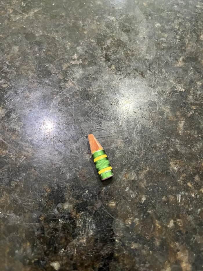 Small colorful toy on a dark textured surface.