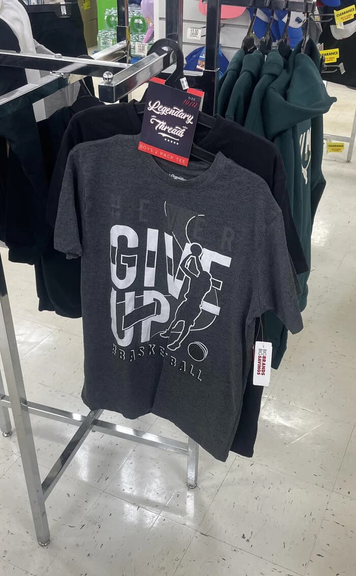 GIVE UP basketball graphic t-shirt on display in retail store.