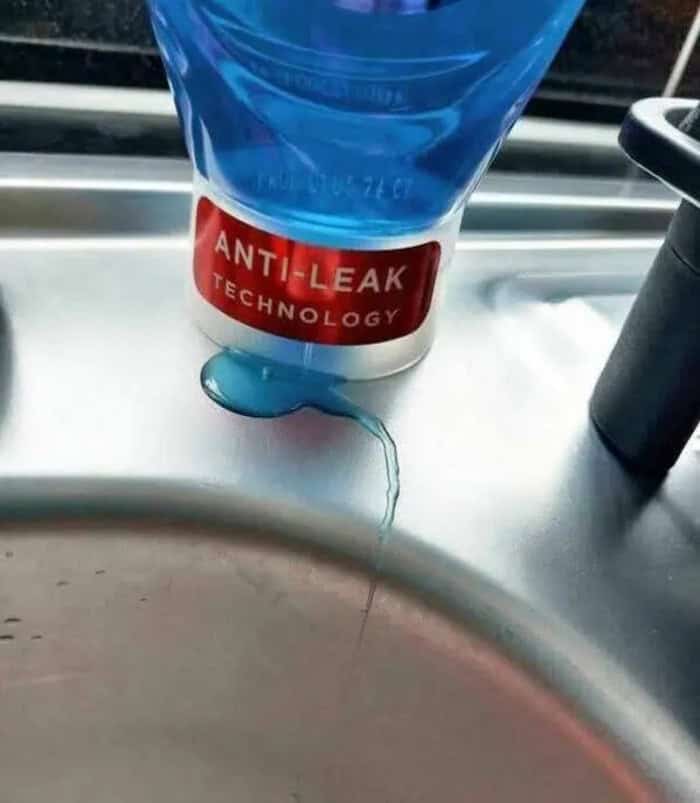 Anti-leak technology label on a blue tube with a small amount of liquid leaking from the opening.