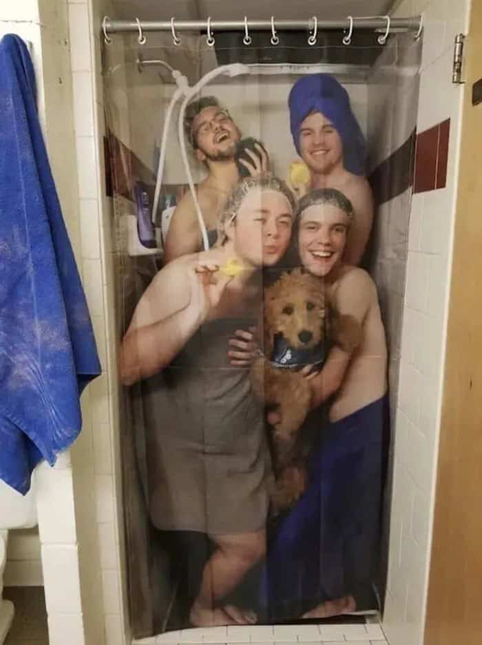 Group of four friends and a dog taking a shower together behind a shower curtain.
