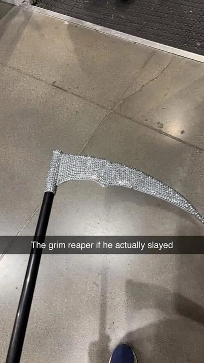 A grim reaper-themed scythe with a rhinestone-encrusted blade on a black handle.