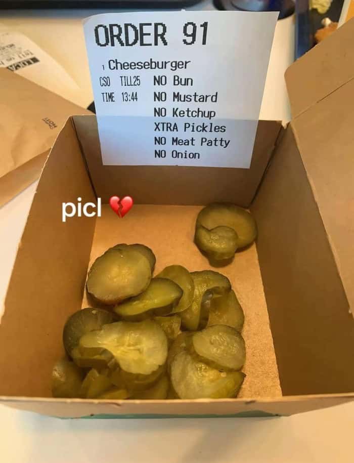 Cheeseburger order with pickles, no bun, mustard, ketchup, meat patty, or onion.