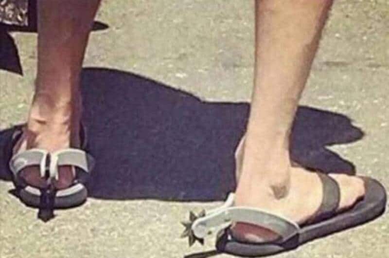 Humorous sandals with star details on the toes, worn outdoors.