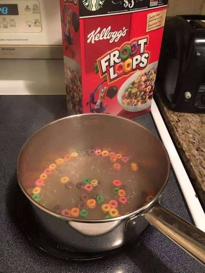 Froot Loops cereal floating in boiling water on stove.