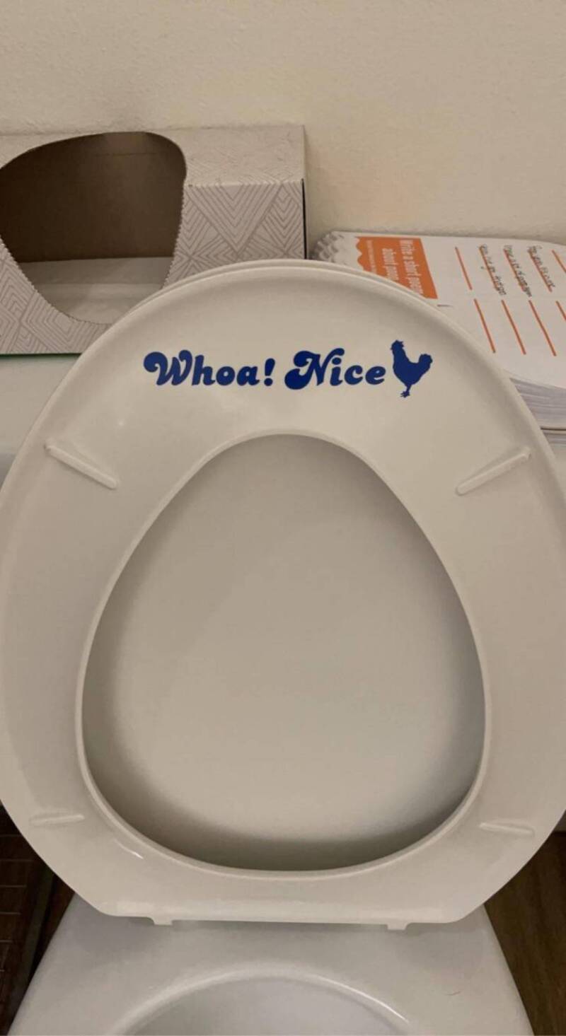 Toilet seat with "Whoa! Nice" message and a small chicken silhouette.